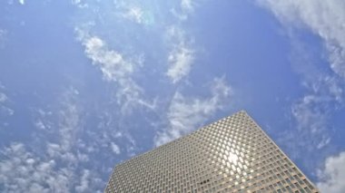 Low Angle Wide Tilt Down Shot Of Sunlit Jacob K. Javits Federal Building In New York City Under Blue Sky