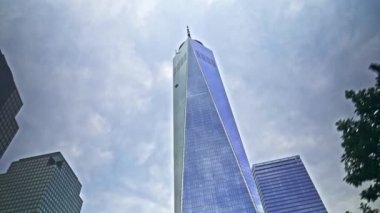 Low Angle Wide Dolly Shot Of One World Trade Centre Reflecting Cloudy Sky In New York City