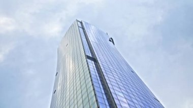 Low Angle Wide Dolly Shot Of Modern Reflective Skyscraper In New York City