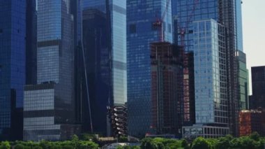 Modern High Rising Glass Buildings of Manhattan with Reflections on Windows, New York. Panning Shot