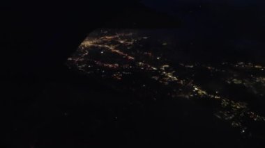 View Through Plane Window on a Night City Lights During the Flight. Panoramic Shot