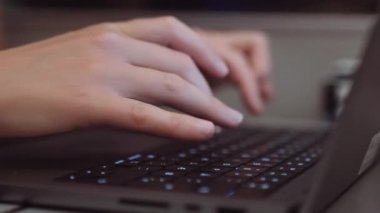 Close-up of Womans Hands Typing on a Laptop While Going by Train in the Evening. Slow Motion Shallow Focus Shot