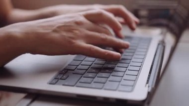 Close-up of Womans Hands Typing on a Laptop While Going by Train. Slow Motion Bokeh Shot