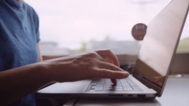 Womans Hands Typing on a Laptop While Going by Train. Slow Motion Bokeh Shot