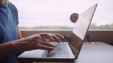 Womans Hands Typing on a Laptop While Going by Train. Slow Motion Bokeh Shot