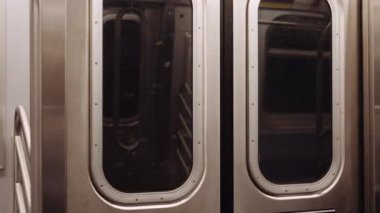 Inside View of a Subway Carriage Doors While the Train Is on Ride. Close-up Handheld Shot