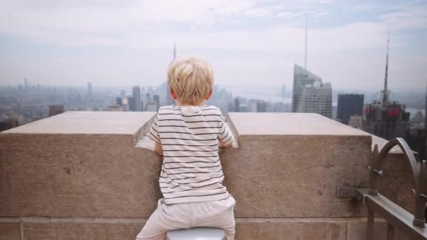 Wide Slow Motion Handheld Shot Passing Young Boy Sitting Rooftop — 图库视频影像