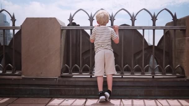 Wide Slow Motion Dolly Shot Boy Standing Rooftop Looking Railings — Stock video