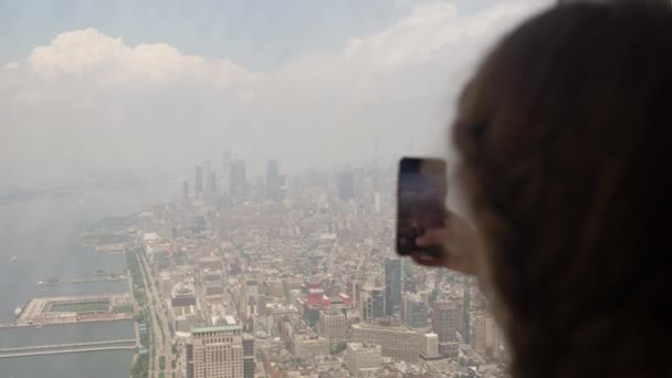 Medium Slow Motion Handheld Shot Girl Filming Smartphone Window Skyscraper — Vídeo de stock