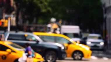 Zebra Crossing with Pedestrians and Intersection with Traffic on the Road of Midtown New York. Defocused Cityscape. Slow Motion Shot