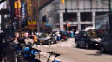 Zebra Crossing with Pedestrians and Intersection with Traffic on the Road of Midtown New York. Defocused Cityscape. Slow Motion Static Shot. View From a Sidewalk