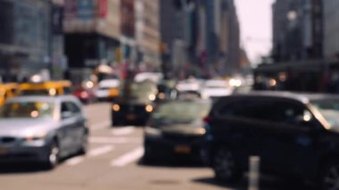 Zebra Crossing and Traffic on the Road of Midtown New York. Defocused Cityscape. Slow Motion Static Shot. View From a Sidewalk