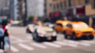 Zebra Crossing with Pedestians and Traffic on the Road of Midtown New York on a Bright Sunny Day. Defocused Cityscape. Slow Motion Panning Shot