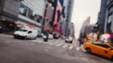 Intersection with Crosswalk and Traffic on Road of New York. Defocused Cityscape on a Bright Sunny Day. Slow Motion Shot
