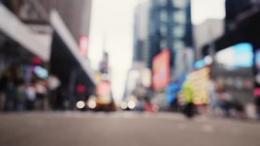 Intersection with Pedestrians on a Crosswalk and Traffic on a Road of New York. Black Car is Passing by the Camera. Defocused Cityscape. Slow Motion Shot