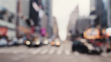 Intersection with Crosswalk and Traffic on a Road of New York. Defocused Cityscape. Slow Motion Shot