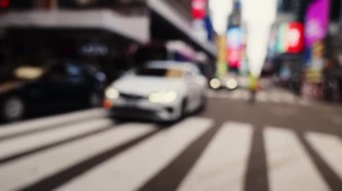Zebra Crossing and Traffic on the Road of Midtown New York. Defocused Cityscape. Cars Passing by the Camera. Slow Motion Handheld Shot