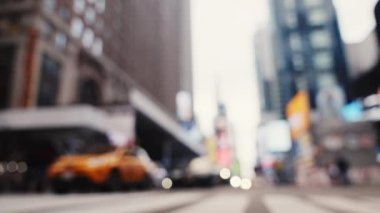 Zebra Crossing and Traffic on the Road of Midtown New York. Defocused Cityscape. Cars Passing by the Camera. Slow Motion Low Angle Shot