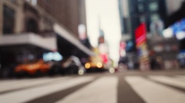 Zebra Crossing and Traffic on the Road of Midtown New York. Defocused Cityscape. Cars Passing by the Camera. Slow Motion Handheld Shot