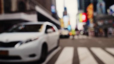 Zebra Crossing and Traffic on the Road of Midtown New York. Defocused Cityscape. Cars Passing by the Camera. Slow Motion Panning Shot