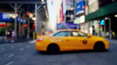 Intersection with Crosswalk and Few Cars Driving on a Road of New York. Defocused Cityscape. Slow Motion Trucking Shot