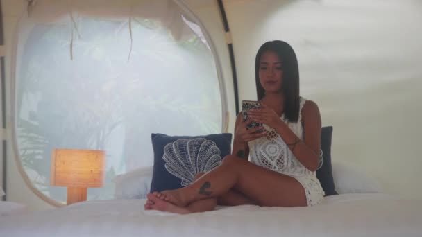 Pretty Asian Woman Sitting Bed Luxury Tent House Using Her — Stockvideo