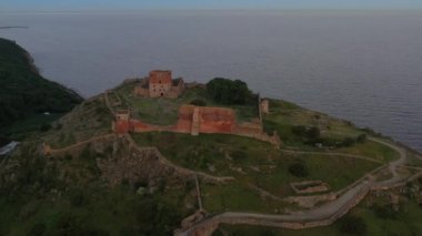 Aerial of Impressive Medieval Fortress of Hammershus Ruins at sunset, Denmark. Beautiful Landscape. Camera Slowly Moves Downwards