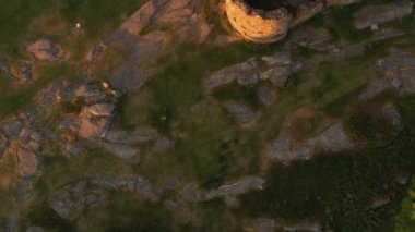 Aerial of Impressive Medieval Fortress of Hammershus Ruins at sunset, Denmark. Beautiful Landscape. Top Down Low Altitude Shot