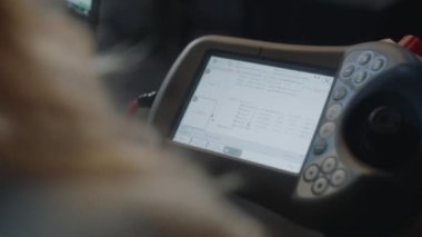 Close Up Handheld Shot Of Monitor Hooked Up To Laptop With Data Flowing To Screen