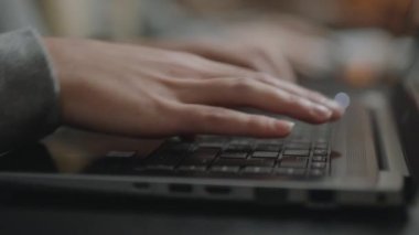 Close Up Handheld Shot Of Person Typing On Laptop