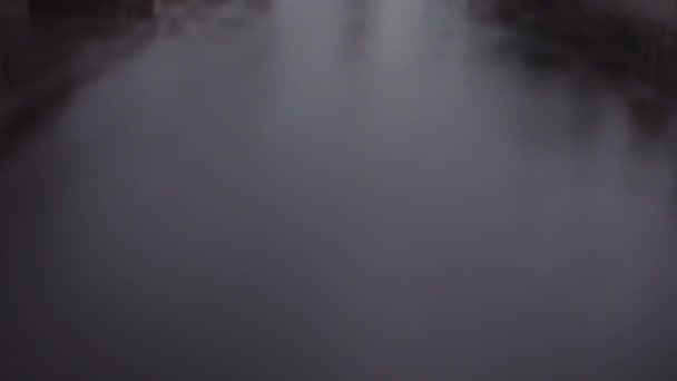 Man Backpack Walking Wet Asphalt Road Reflections Surface Residential Houses — Stockvideo