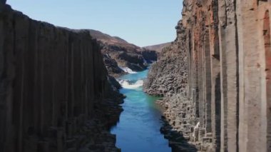 Wide Slow Motion Drone Flight Over River And Through Studlagil Canyon, Glacier Valley, Jokuldalur, Iceland
