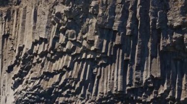 Medium Slow Motion Drone Shot Tilting Down Over Basalt Rocks To River Of Studlagil Canyon, Glacier Valley, Jokuldalur, Iceland