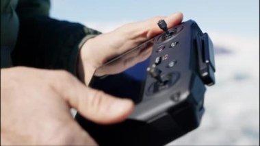 Close-up of Drone Remote Control in Mans Hands. Man Pulls the Stick on Remote. Slow Motion Shot