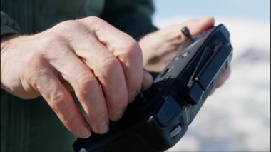 Close-up of Drone Remote Control in Mans Hands. Man Turns the Stick on Remote. Slow Motion Shot