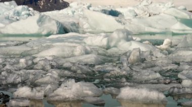 Close-up of Ice Formations of Jokulsarlon Glacier Lagoon Near Diamond Beach, South Coast of Iceland. Amazing Winter Scenery. Slow Motion Panning Shot