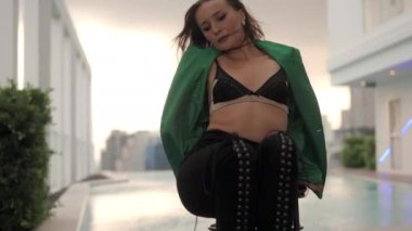 Slow Motion Medium Zoom In On Sensuous Windswept Dancer Looking At Camera