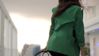 Slow Motion Medium Dolly Shot Of Dancer Moving Round Chair And Dancing At Poolside In High Heels