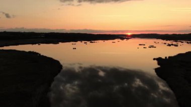 Aerial Over the River Near City of Aarhus, Denmark. Beautiful Landscape at Stunning Pink Sunset. Sun and Skies Reflections on the River Surface. Panoramic Shot