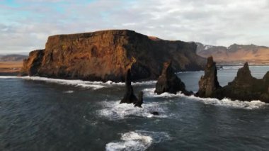 Wide Drone Flight Arcing Round Sea Stacks Off Rocky Coastline, Iceland