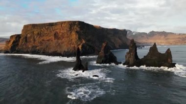 Wide Drone Flight Arcing Round Sea Stacks Off Rocky Coastline, Iceland