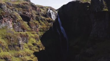 Aerial View of Majestic Glymur Waterfall In West Iceland on a Bright Sunny Day. Unique Nature of Iceland. Camera Moves Upwards