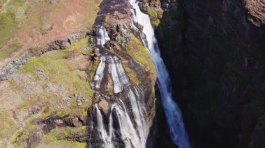 Aerial View of Majestic Glymur Waterfall In West Iceland on a Bright Sunny Day. Unique Nature of Iceland. High Angle Zoom In Shot