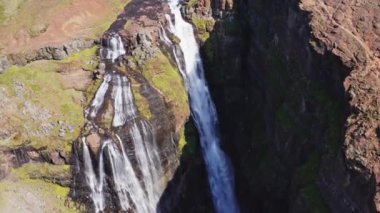 Aerial View of Majestic Glymur Waterfall In West Iceland on a Bright Sunny Day. Unique Nature of Iceland. High Angle Arc Shot