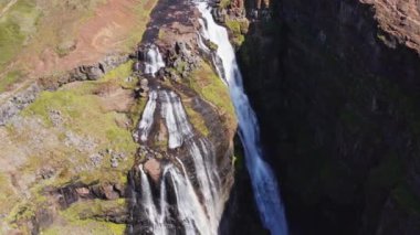 Aerial View of Majestic Glymur Waterfall In West Iceland on a Bright Sunny Day. Unique Nature of Iceland. High Angle Trucking Right Shot