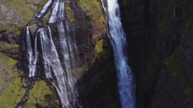 Aerial View of Majestic Glymur Waterfall In West Iceland on a Bright Sunny Day. Unique Nature of Iceland. Tilt Up Shot