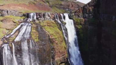 Aerial View of Majestic Glymur Waterfall In West Iceland on a Bright Sunny Day. Unique Nature of Iceland. Zoom In Shot