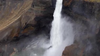 Aerial Over Majestic Haifoss Waterfall. Spectacular Scenery of Iceland.  Slow Motion Arc Shot