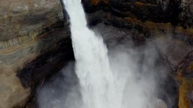 Aerial of Majestic Haifoss Waterfall. Spectacular Scenery of Iceland.  Slow Motion High Angle Shot. Camera Moves Up