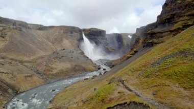 Aerial of Majestic Haifoss Waterfall, River and the Valley. Spectacular Scenery of Iceland.  Wide Panoramic Shot. Camera Moves Forwards